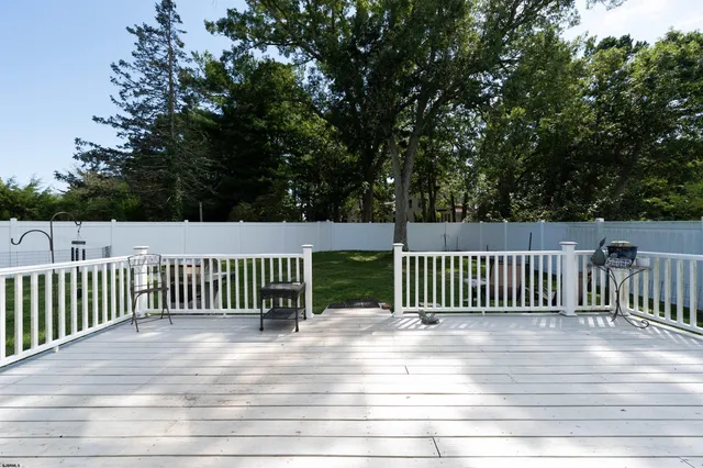a view of a deck with a floor to ceiling window