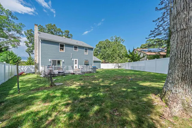 a view of house with backyard