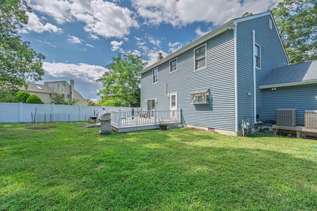a view of a house with a yard and sitting area