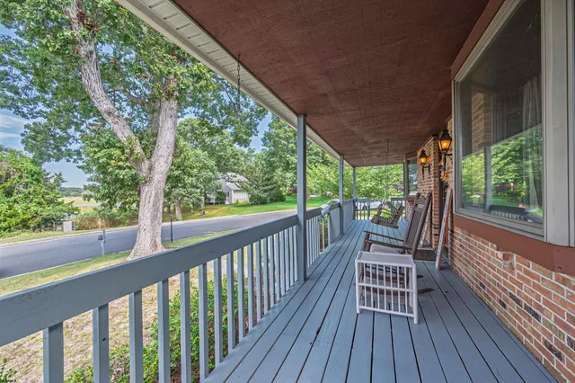 a view of a two chairs with table in balcony with wooden floor