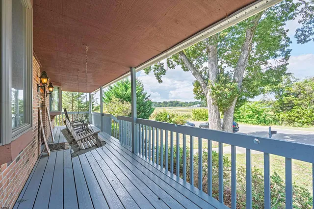 a view of two chairs in a balcony