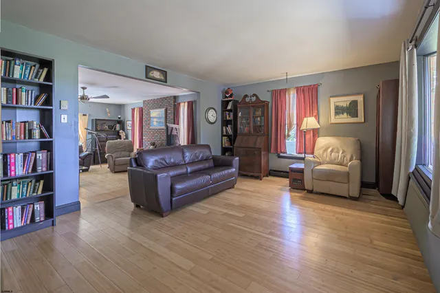 a living room with furniture and a book shelf