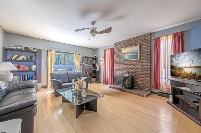 a living room with fireplace furniture and a flat screen tv