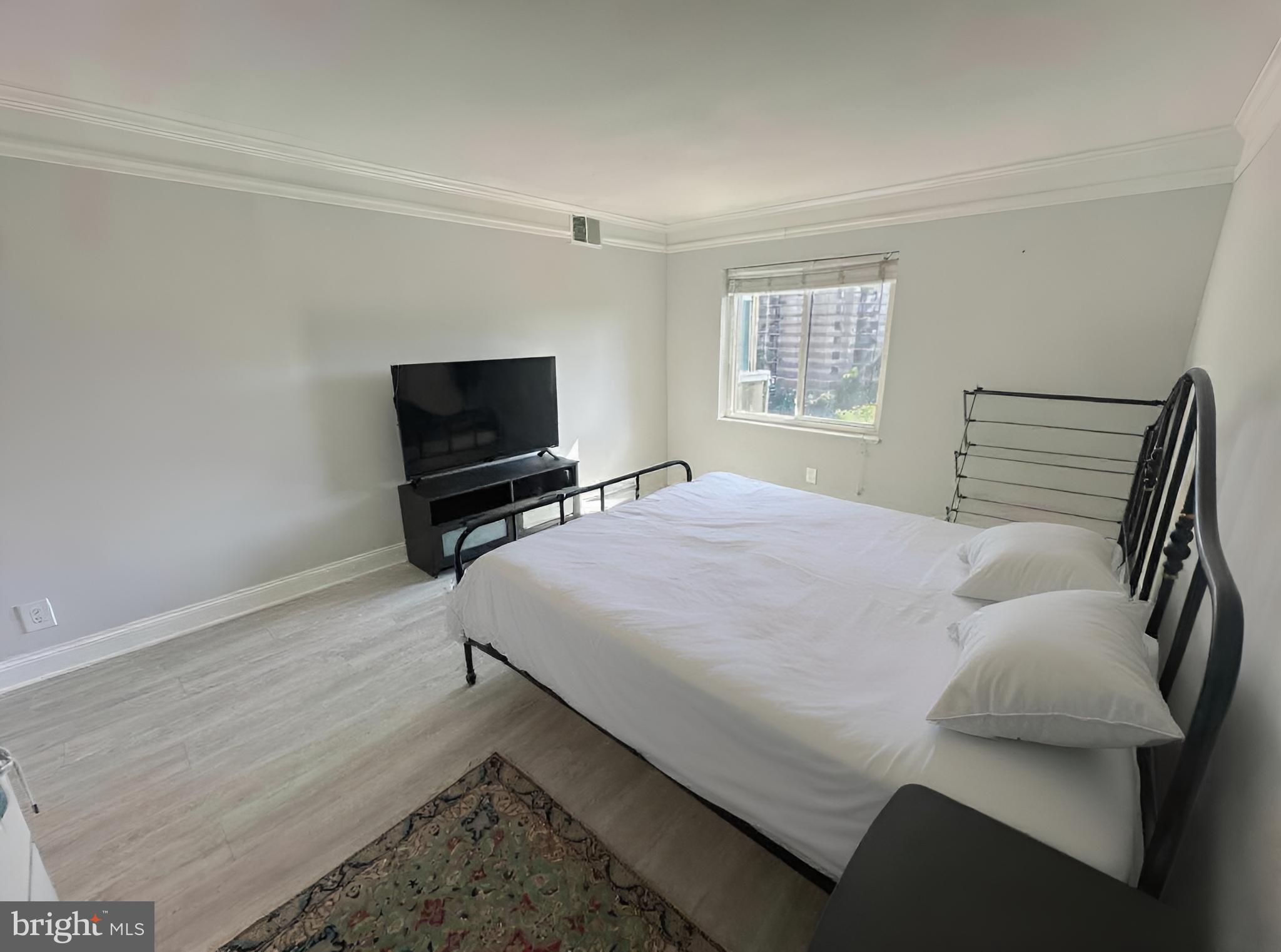 8350 Greensboro Drive, Unit 517 McLean, VA 22102 - Photo 11 of 35 a bedroom with a bed and a flat screen tv