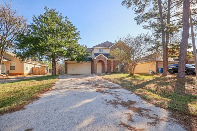 a view of a house with a yard and garage