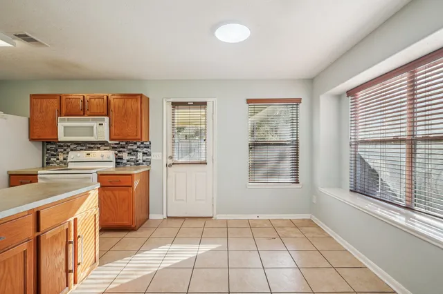 a kitchen with stainless steel appliances a stove sink and cabinets