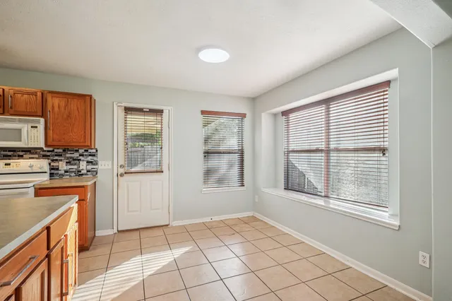 a view of a kitchen with a sink dishwasher and wooden floor
