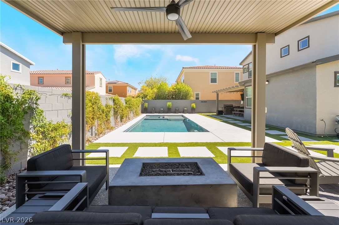 2166 Trivero Street Henderson, NV 89044 - Photo 35 of 61 A spacious covered patio with a fire pit offers a perfect view of the refreshing in-ground pool.