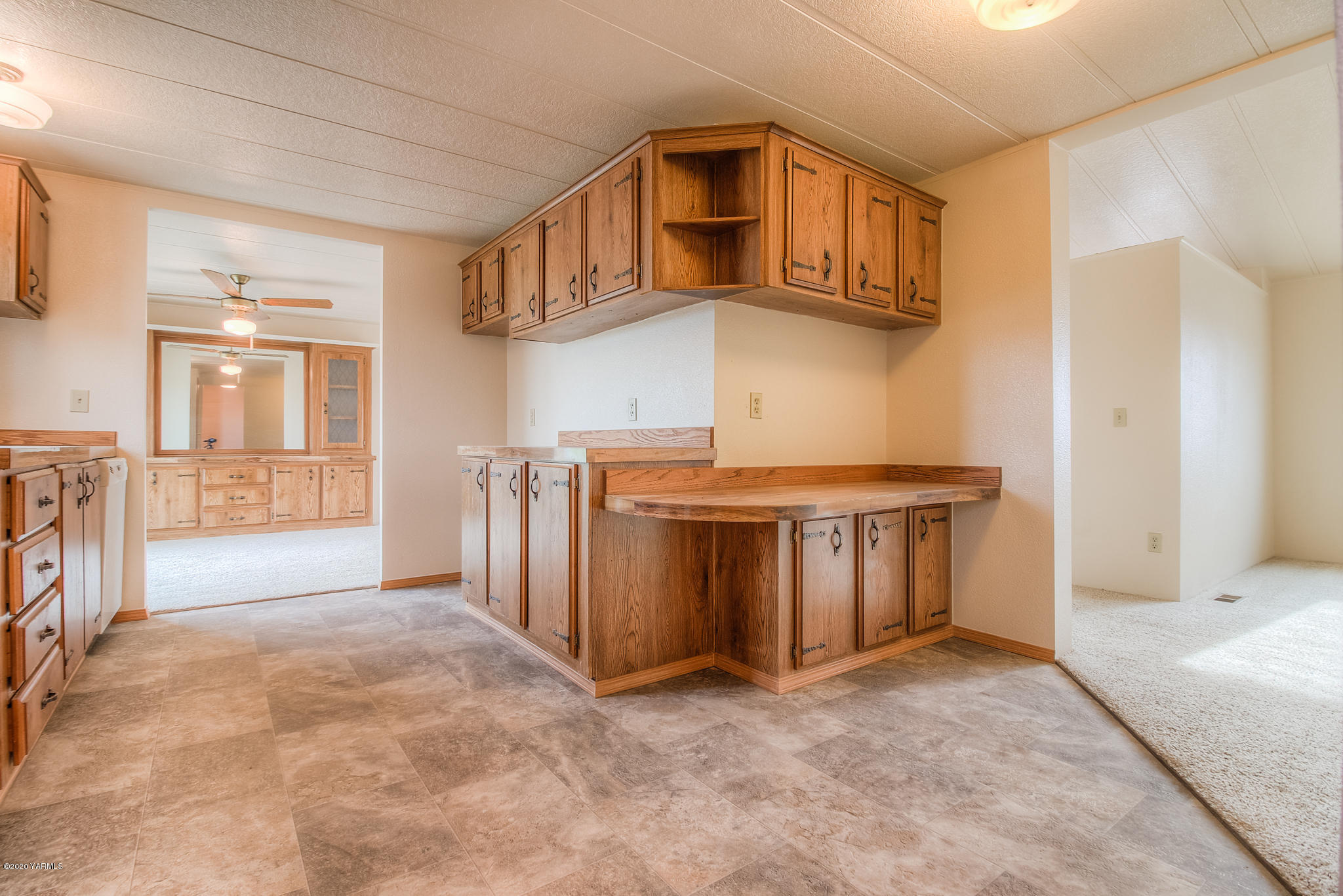 3641 Independence Road Sunnyside, WA 98944 - Photo 5 of 21 a view of an empty room with kitchen and wooden floor
