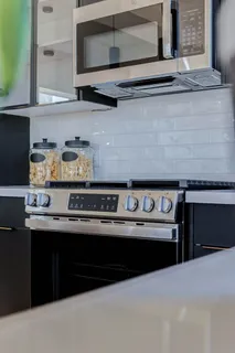 a kitchen with stainless steel appliances granite countertop a stove and a microwave