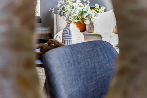 a room with furniture a flat screen tv and a sink