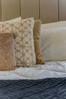 a bed sitting in a bedroom next to a window
