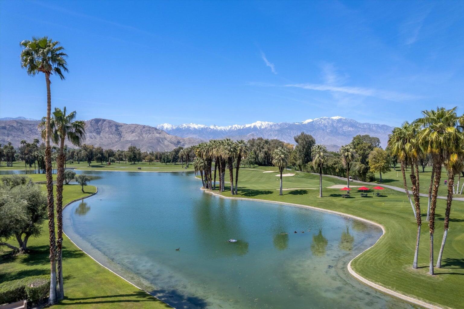 899 Island Drive, Unit 304 Rancho Mirage, CA 92270 - Photo 28 of 30 a view of a lake with a mountain in the background