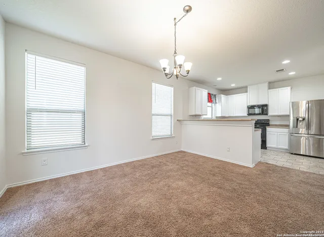 a view of a kitchen with center island and stainless steel appliances