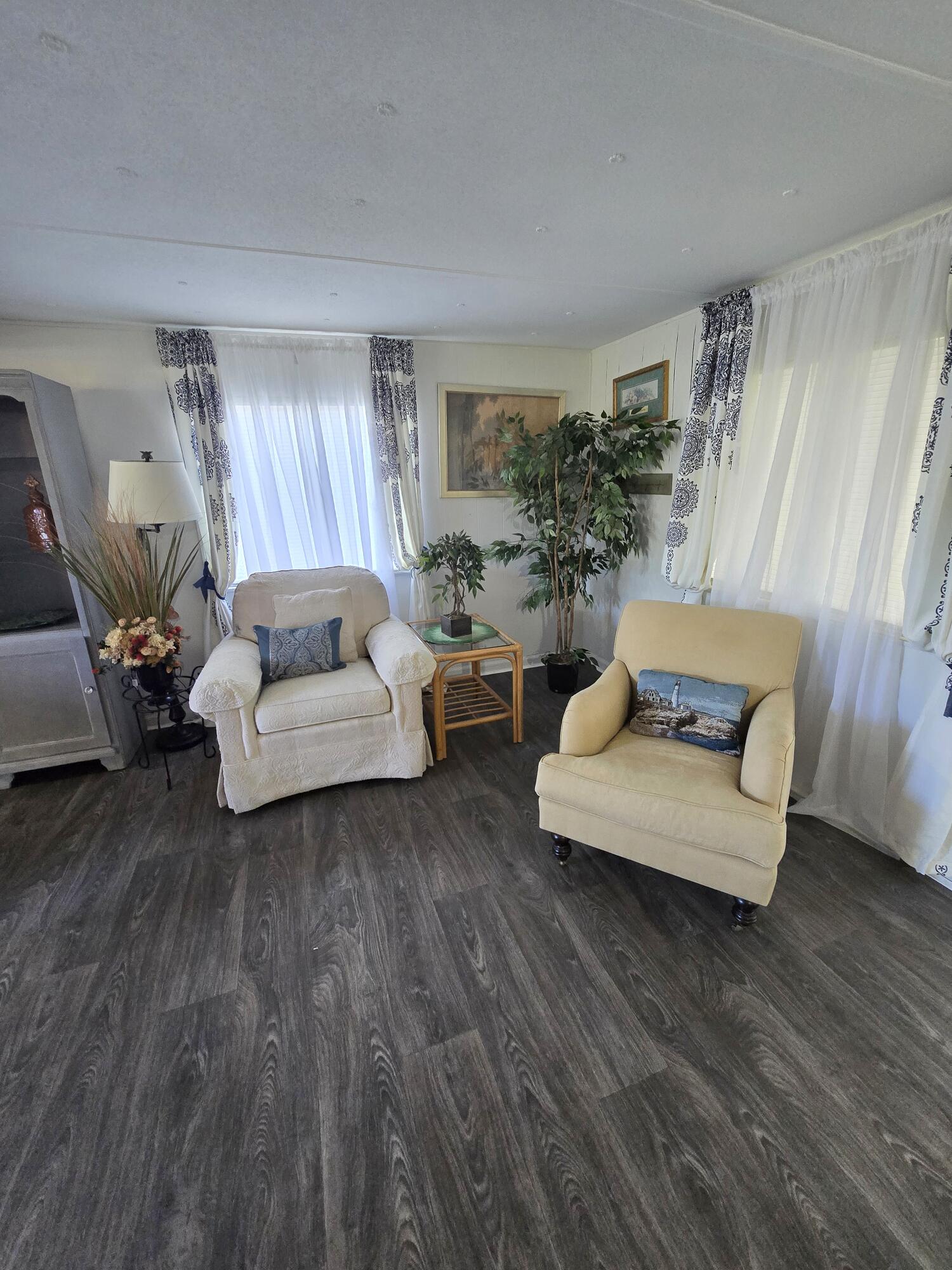 2612 Southeast 29th Street Okeechobee, FL 34974 - Photo 12 of 46 a living room with furniture and a wooden floor