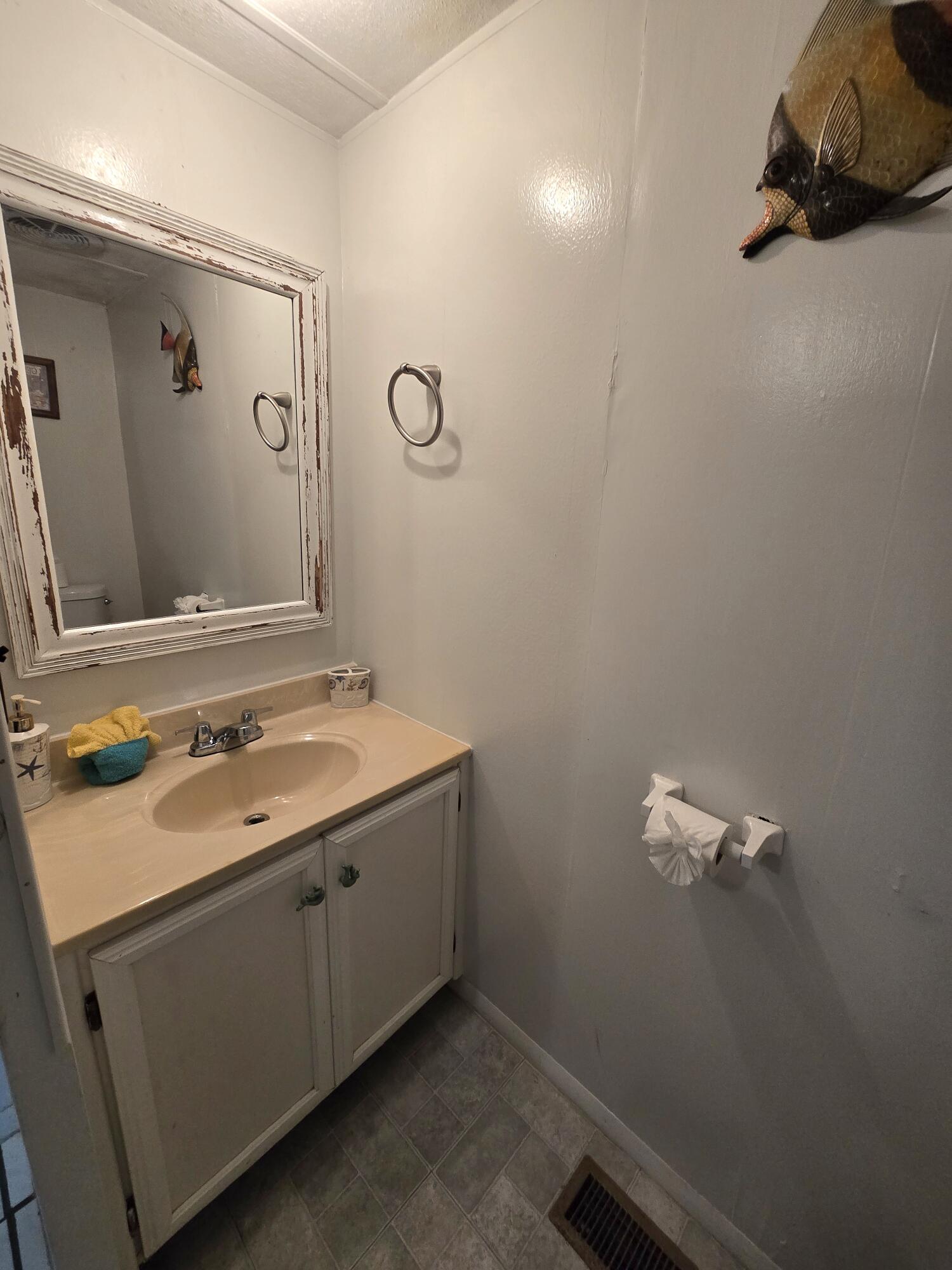 2612 Southeast 29th Street Okeechobee, FL 34974 - Photo 27 of 46 a bathroom with a sink and a mirror