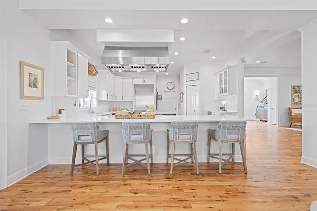 a kitchen with a stove a sink and a refrigerator