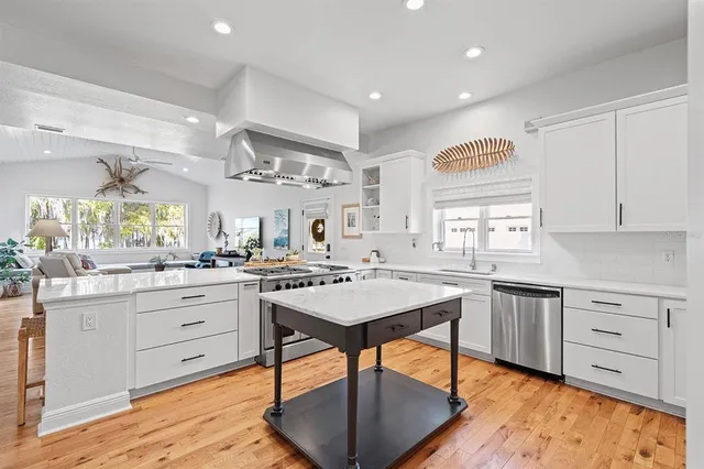 a kitchen with stainless steel appliances granite countertop a sink and a microwave