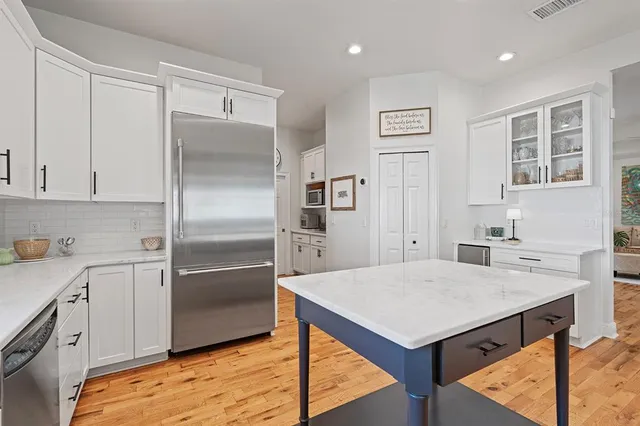 a living room with furniture and a book shelf
