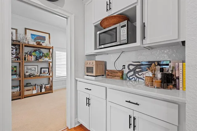 a living room with furniture and a dining table with kitchen view