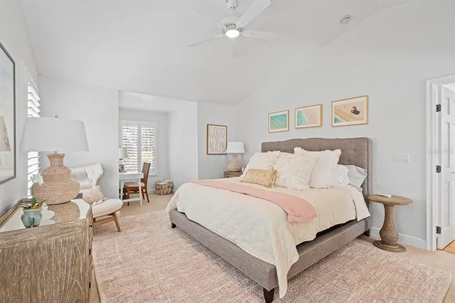 a bedroom with a bed a table and chair