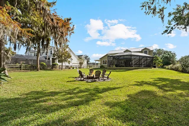 a aerial view of a house with a yard and sitting area
