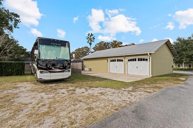 a view of a house with a yard table and chairs