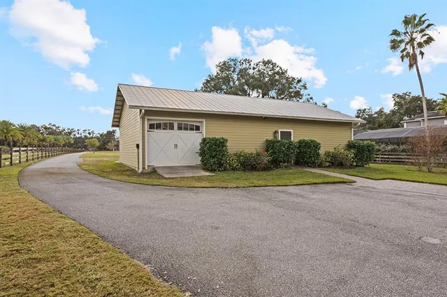 a view of a backyard with chairs