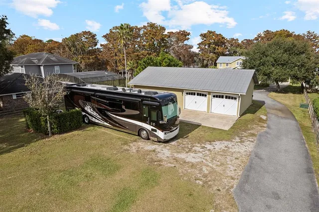 an aerial view of a house with a yard and lake view