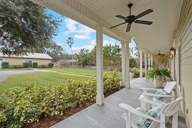 a view of a porch with furniture and garden