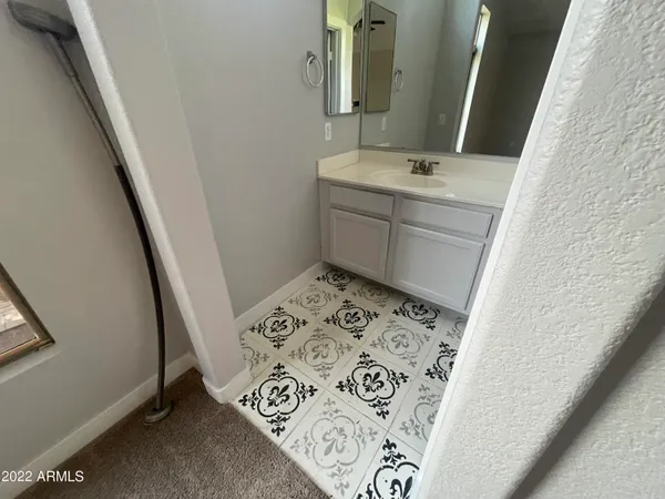 a bathroom with a sink and mirror with window