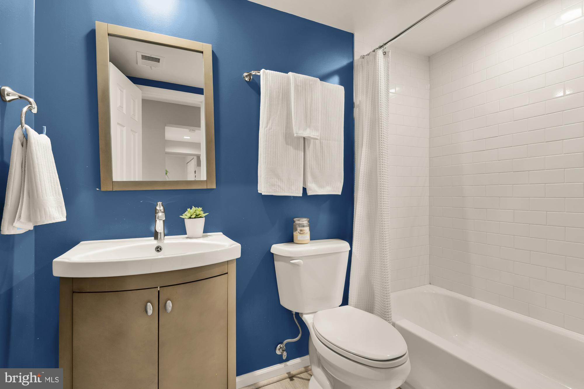 2446 South Walter Reed Drive, Unit B Arlington, VA 22206 - Photo 21 of 26 Chic bathroom with vibrant blue accents.