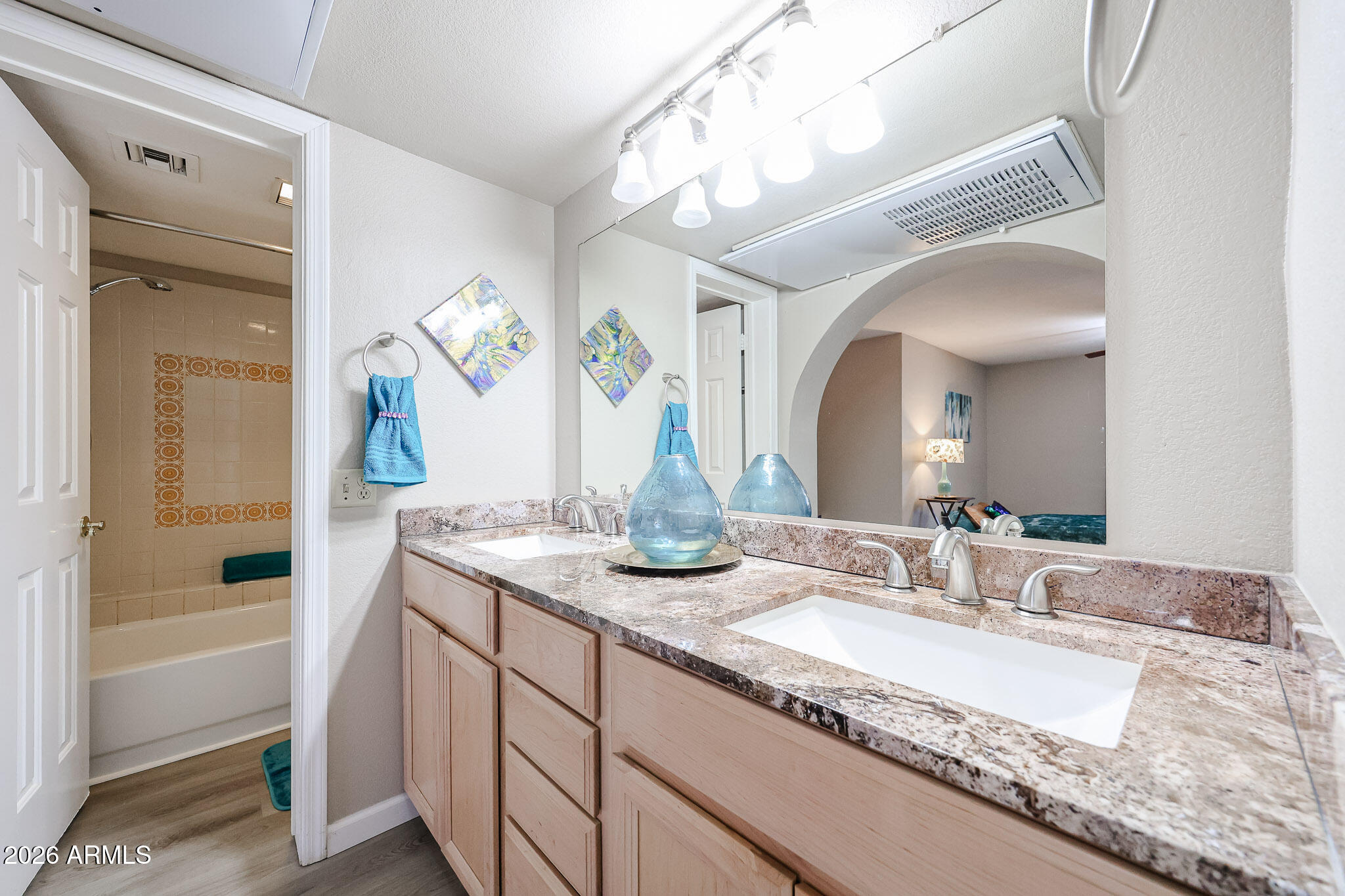 10410 North Cave Creek Road, Unit 1011 Phoenix, AZ 85020 - Photo 19 of 54 a bathroom with a granite countertop sink a toilet and a mirror