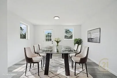 a view of a dining room with furniture and a potted plant