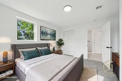 a bedroom with a large bed and a potted plant