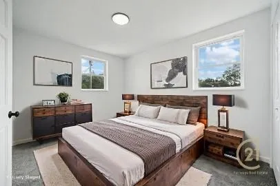 a bedroom with a bed a couch and dresser