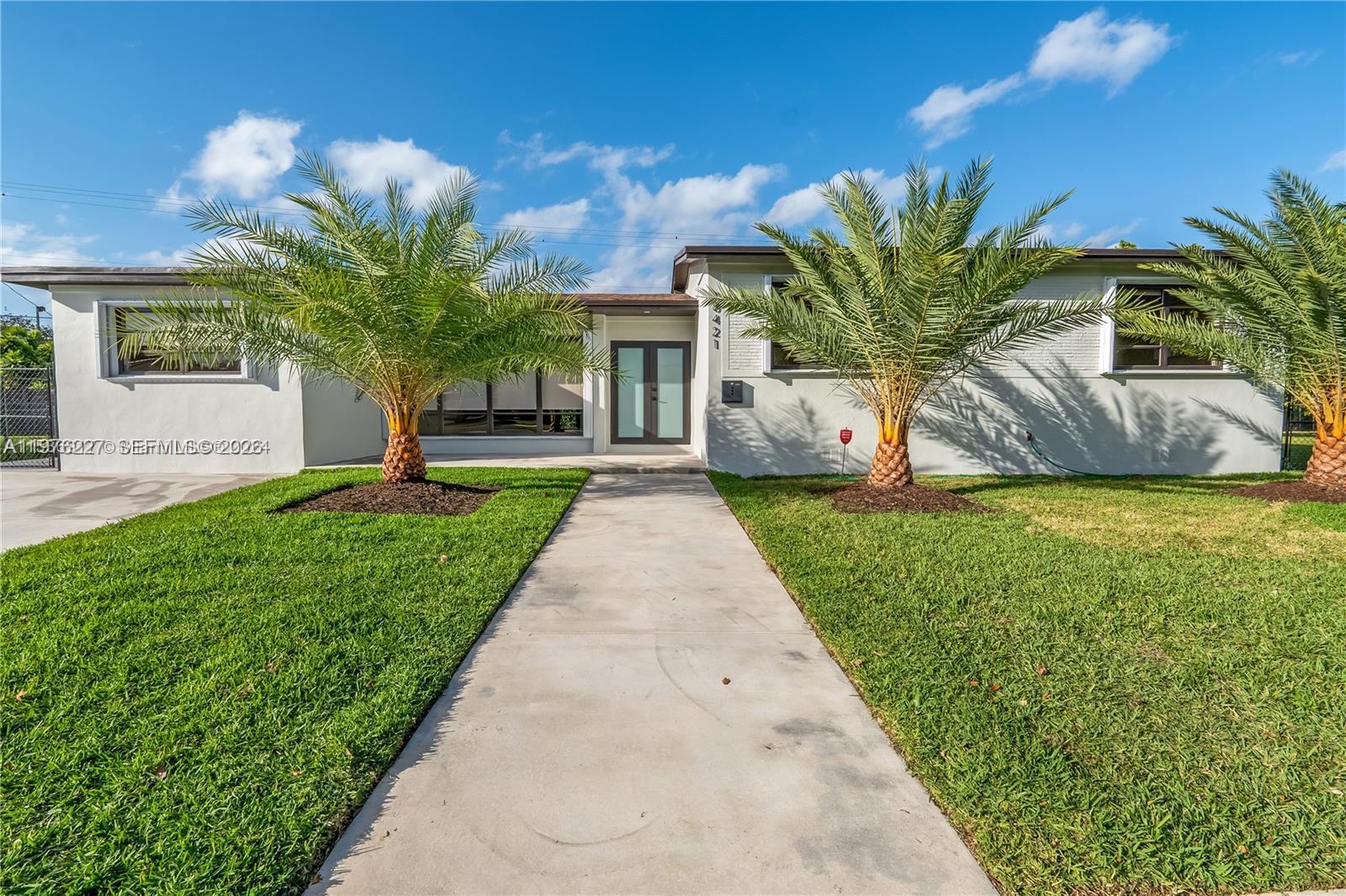 a front view of house with yard and green space