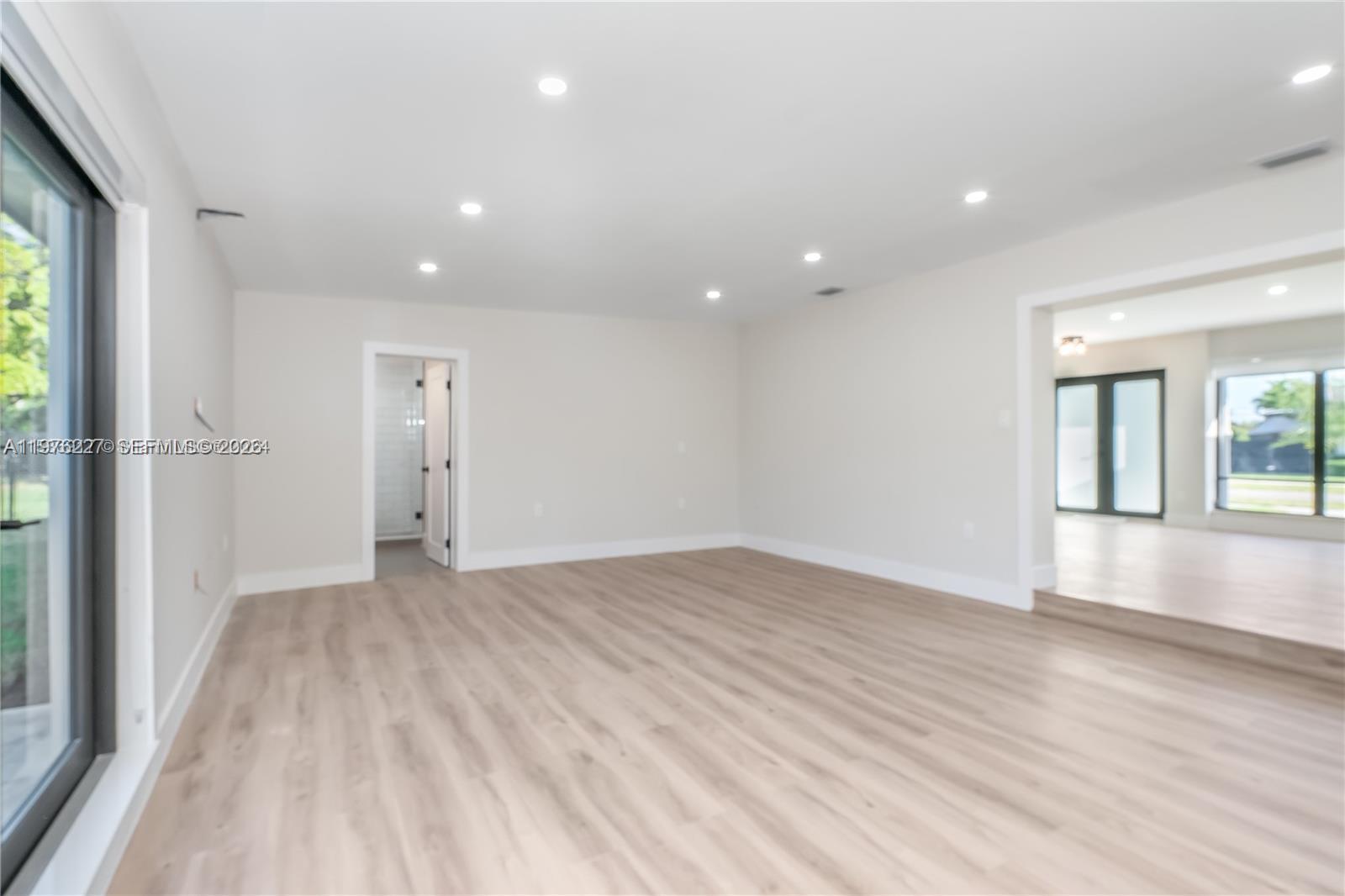 8421 Southwest 27th Terrace Miami, FL 33155 - Photo 17 of 22 a view of empty room with wooden floor and fan