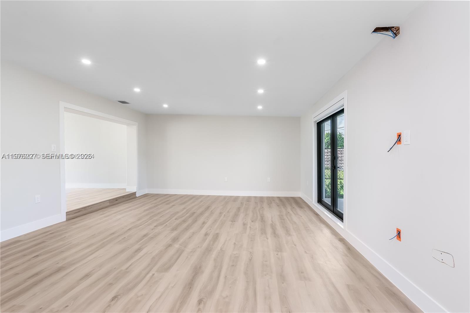 8421 Southwest 27th Terrace Miami, FL 33155 - Photo 18 of 22 an empty room with wooden floor and windows