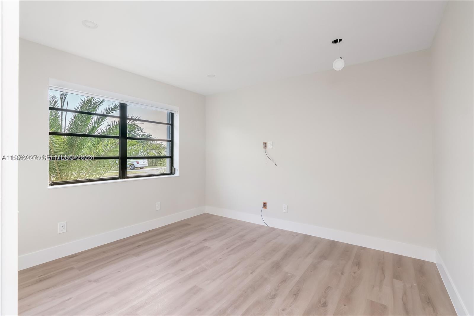 8421 Southwest 27th Terrace Miami, FL 33155 - Photo 19 of 22 wooden floor in an empty room with a window