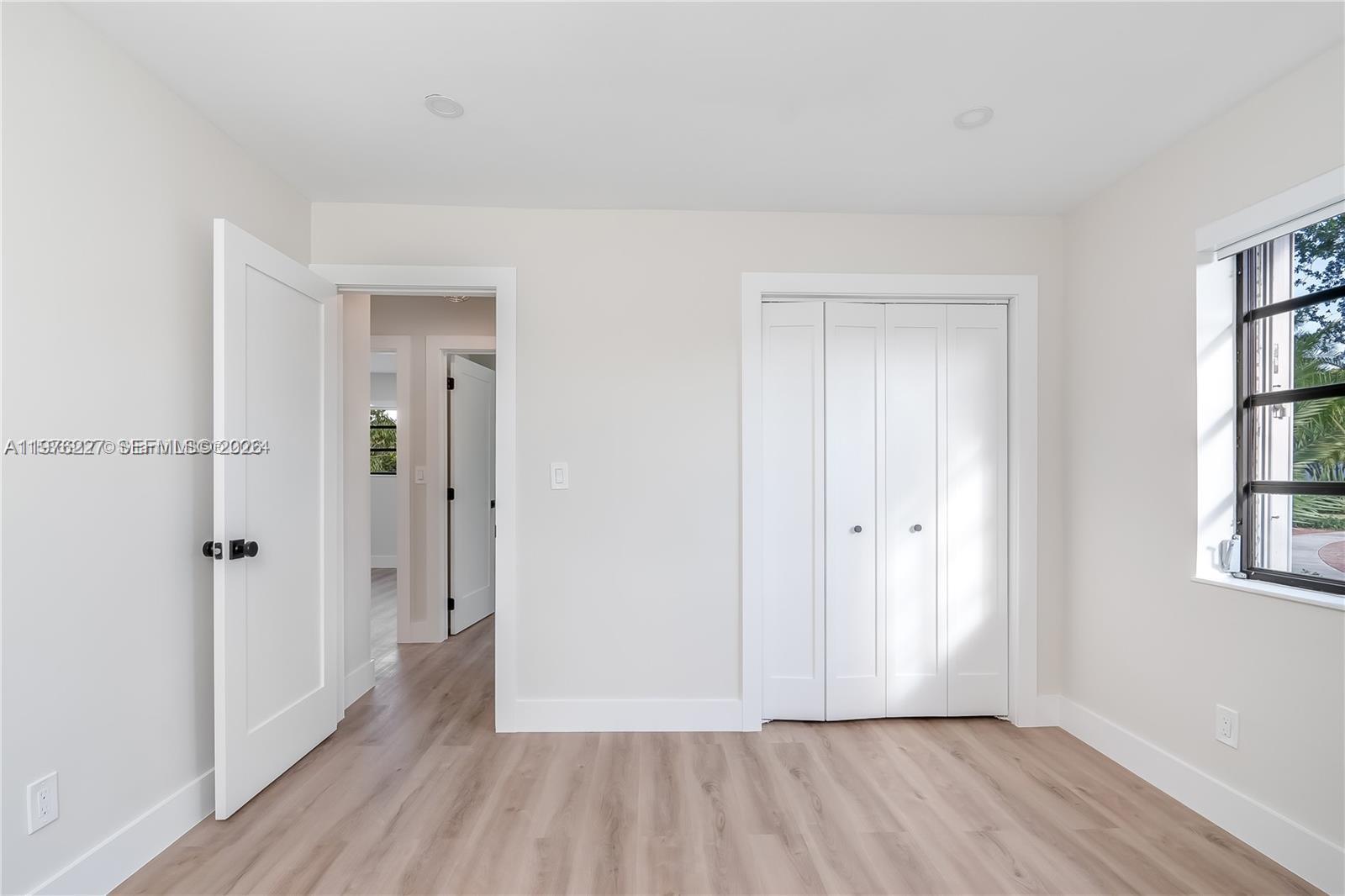 8421 Southwest 27th Terrace Miami, FL 33155 - Photo 20 of 22 a view of a hallway with wooden floor and a bathroom