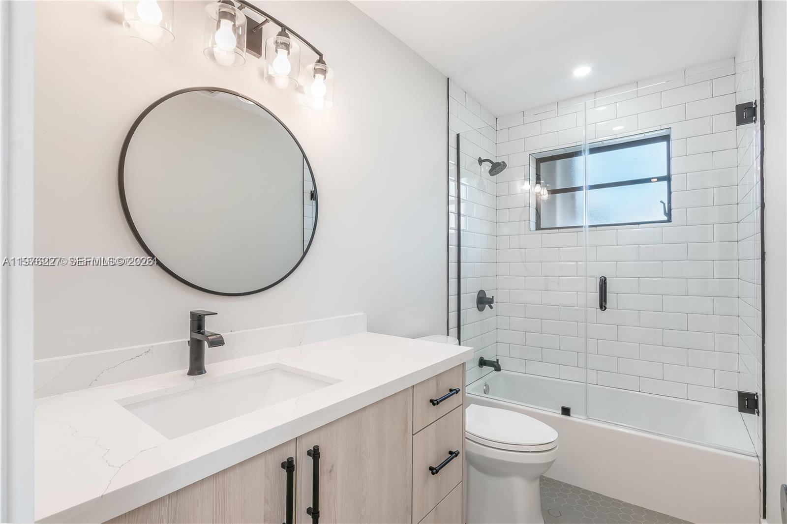 8421 Southwest 27th Terrace Miami, FL 33155 - Photo 5 of 22 a bathroom with a sink a toilet and a mirror