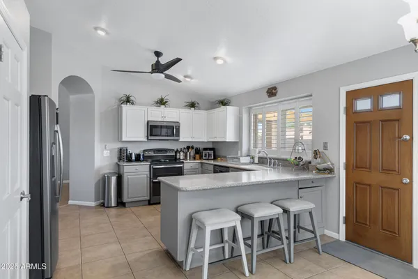 a bedroom with a bed and a flat tv screen on a dresser