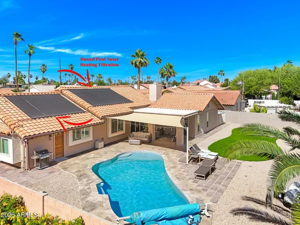 an aerial view of a house with a yard and balcony