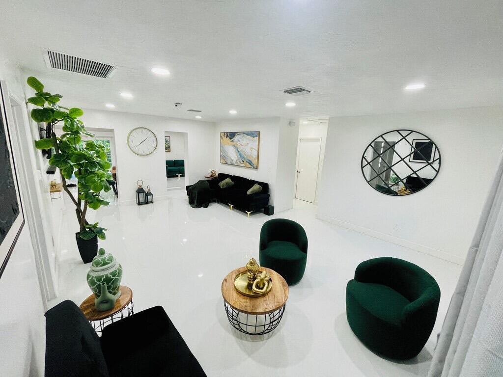 5537 Southwest 6th Street Margate, FL 33068 - Photo 12 of 40 a living room with furniture and a potted plant