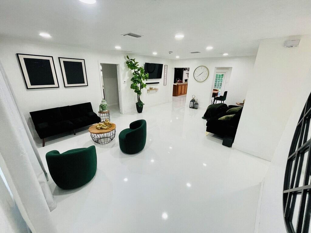5537 Southwest 6th Street Margate, FL 33068 - Photo 13 of 40 a living room with furniture and a flat screen tv