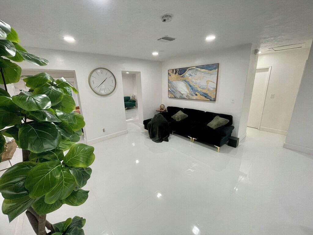 5537 Southwest 6th Street Margate, FL 33068 - Photo 14 of 40 a picture of a floor to ceiling window and a plant