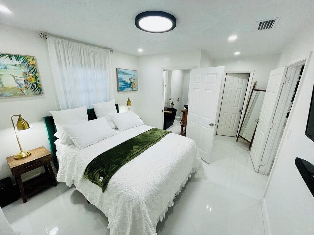 5537 Southwest 6th Street Margate, FL 33068 - Photo 16 of 40 a bed room with a bed and a mirror