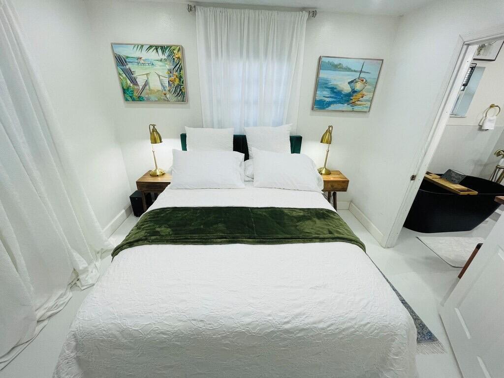 5537 Southwest 6th Street Margate, FL 33068 - Photo 17 of 40 a bed sitting in a bedroom and painting on the wall