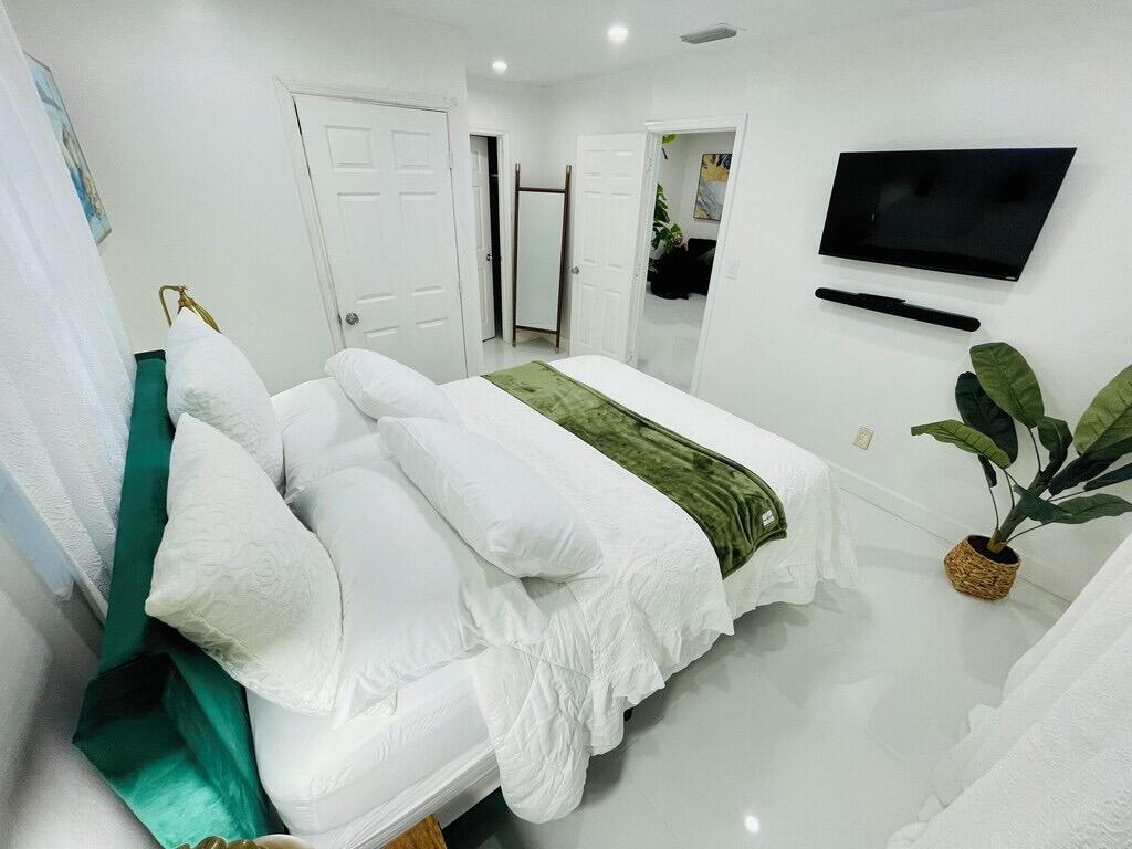 5537 Southwest 6th Street Margate, FL 33068 - Photo 18 of 40 a bedroom with furniture and a flat screen tv